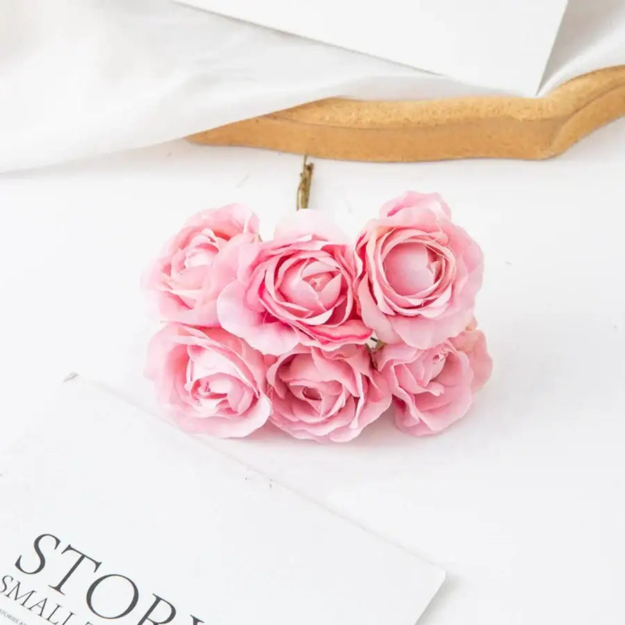 A decorbites artificial rose bouquet with delicate pink layered petals and slender metallic stems for home decor and weddings