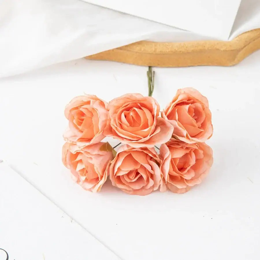 A decorbites artificial rose bouquet featuring five peach-colored roses with layered petals for home decor and weddings