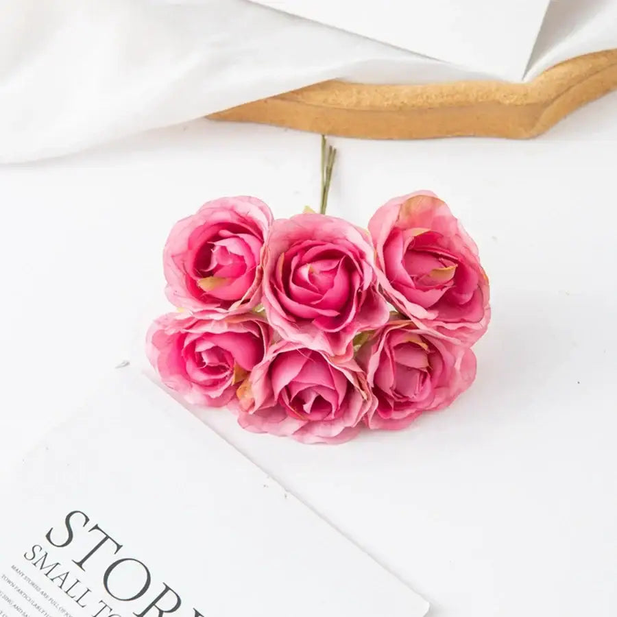 A decorbites artificial rose bouquet featuring five pink artificial roses with layered petals and yellow centers ideal for decor