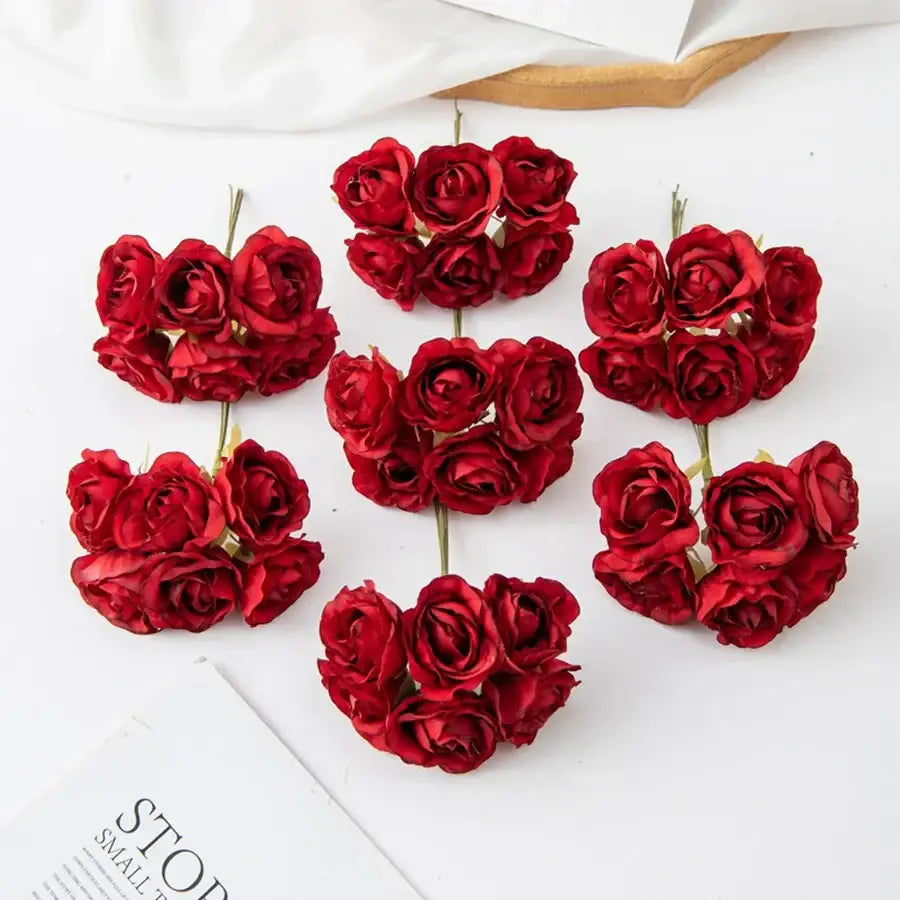 Clusters of vibrant red decorbites artificial rose bouquet with detailed petals on green stems for home decor and weddings