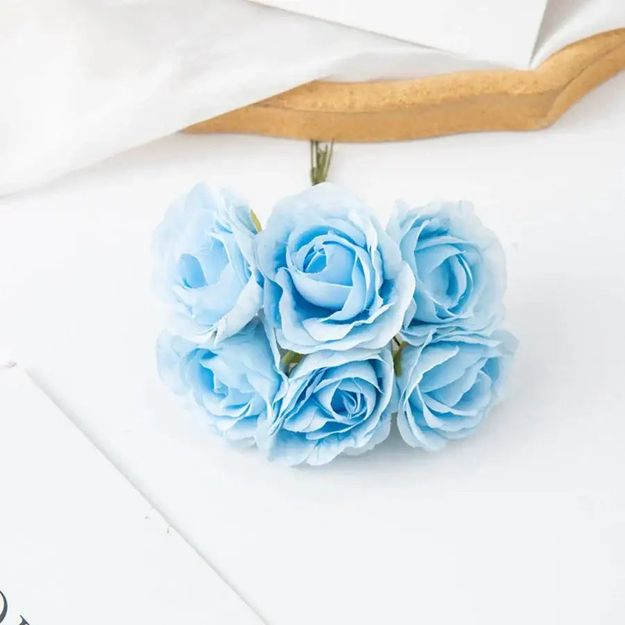 DecorBites artificial rose bouquet featuring a delicate cluster of light blue artificial roses with green stems
