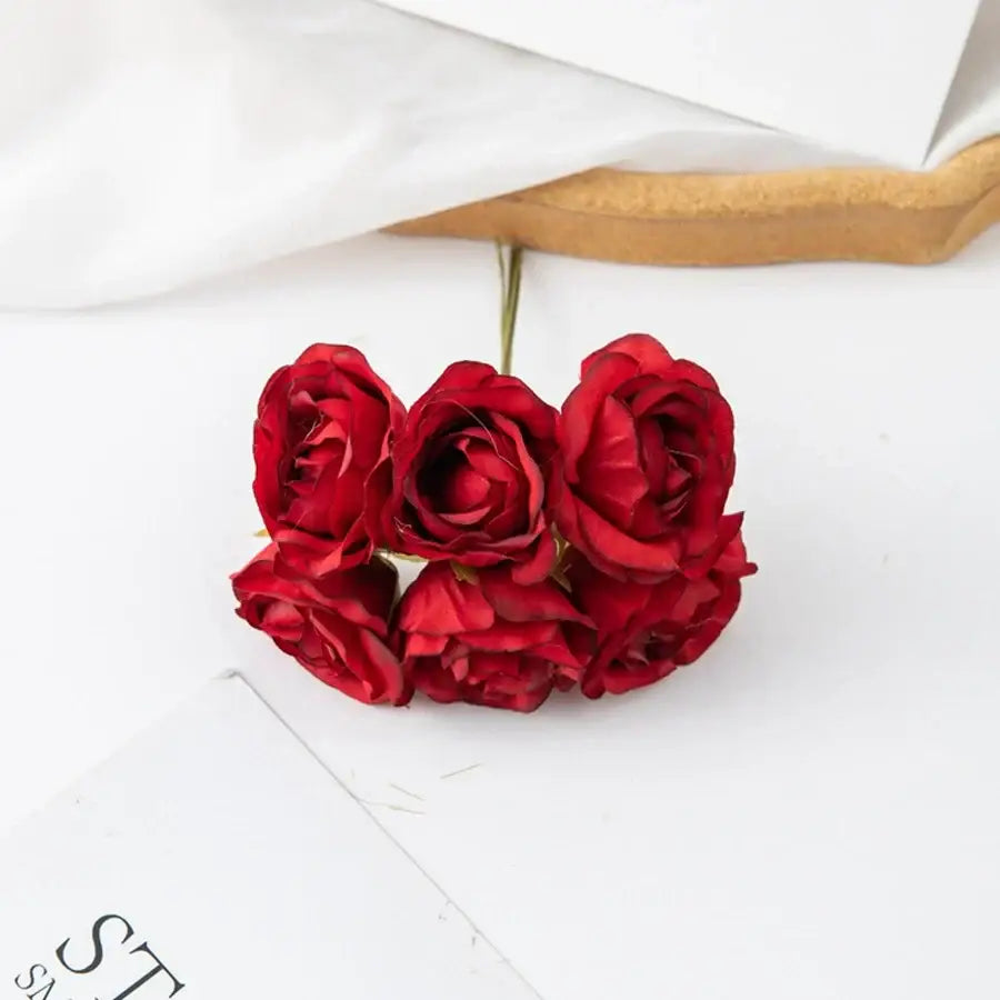 A decorbites artificial rose bouquet with five deep red layered petals and slender green stems for home decor and weddings