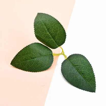 Three artificial green leaves with detailed veins and serrated edges on a light yellow stem for silk greenery wreaths