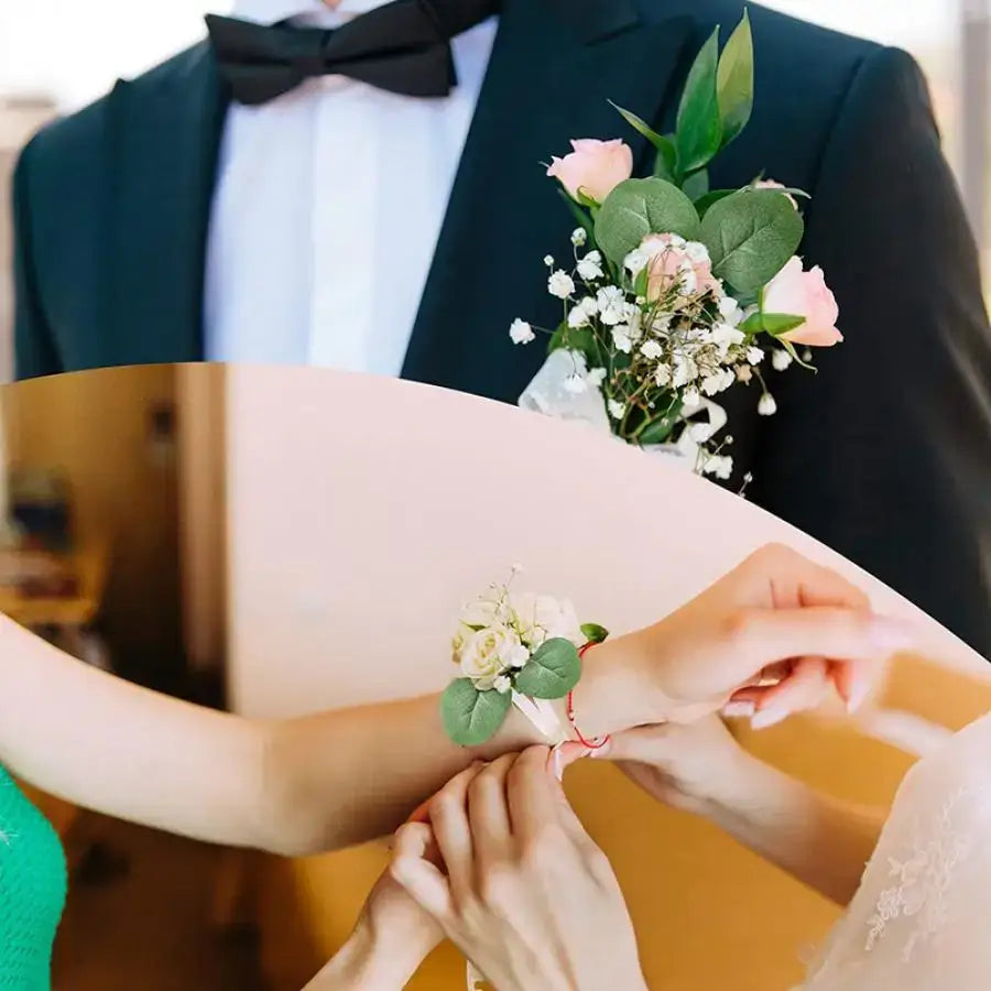A delicate wrist corsage of decorbites artificial roses with eucalyptus for home wedding christmas decor use