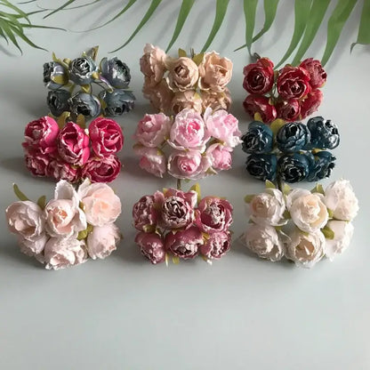 A collection of decorbites artificial roses bridal bouquet featuring fabric pastel and vibrant hues with green stems for weddings