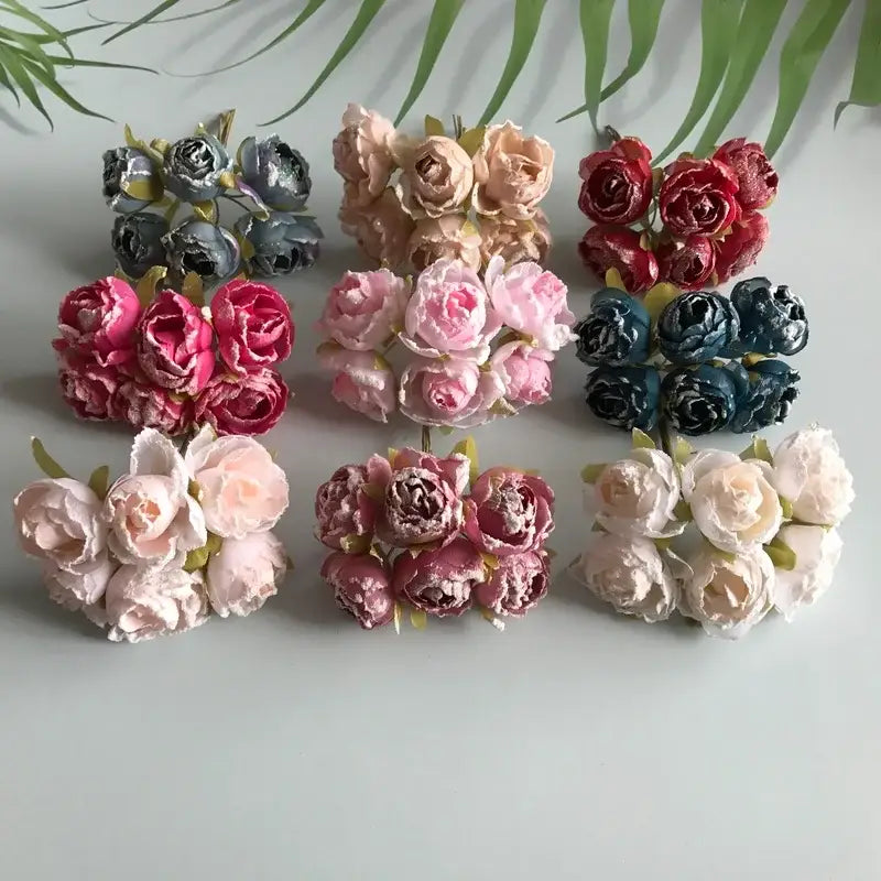 A collection of decorbites artificial roses bridal bouquet featuring fabric pastel and vibrant hues with green stems for weddings