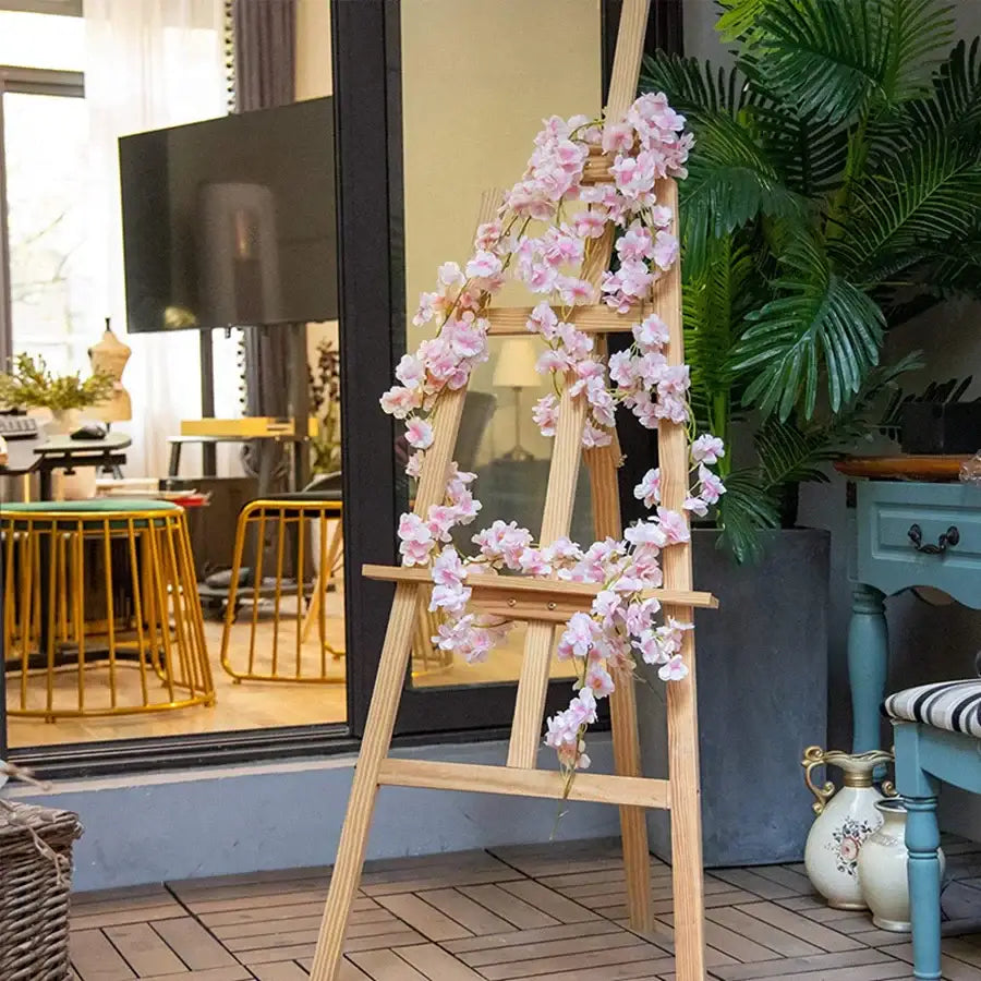 DecorBites artificial sakura pink vine cascading over light wood easel ideal for wedding garden decor with artificial sakura flowers