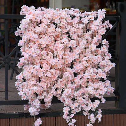 A cascading arrangement of decorbites artificial sakura pink flowers vine with delicate petals for wedding garden decor