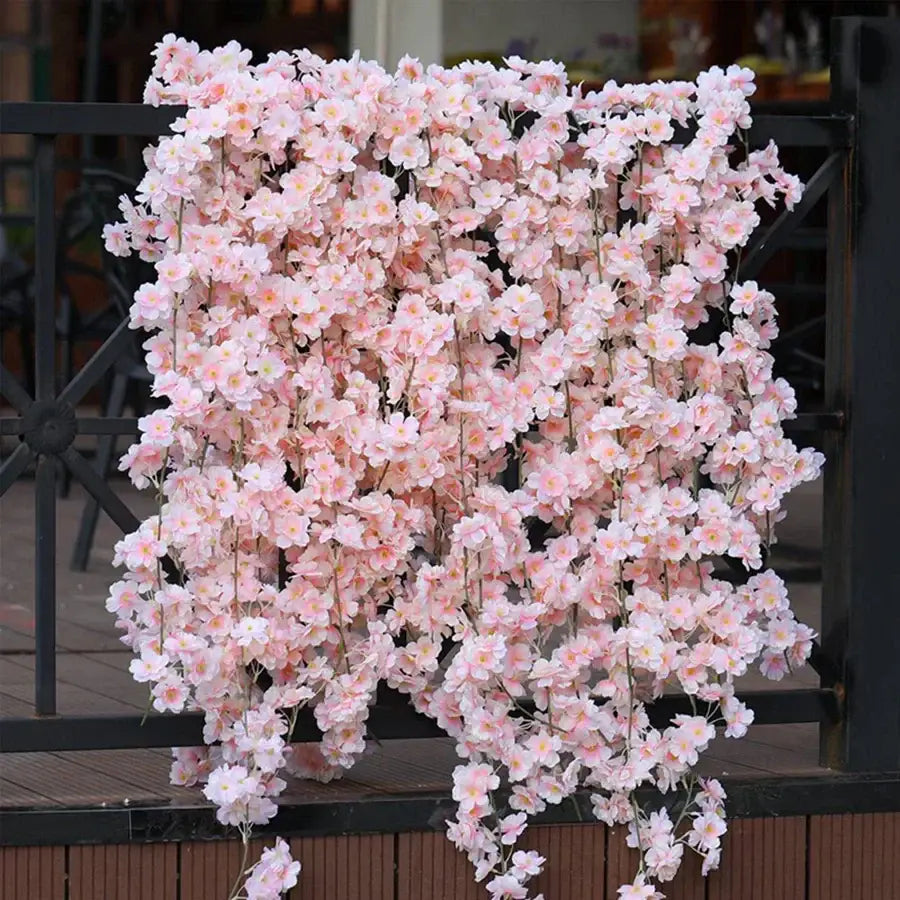 A cascading arrangement of decorbites artificial sakura pink flowers vine with delicate petals for wedding garden decor