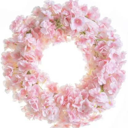 A delicate pink decorbites artificial sakura flowers vine wreath with soft layered petals and subtle green stems for decor