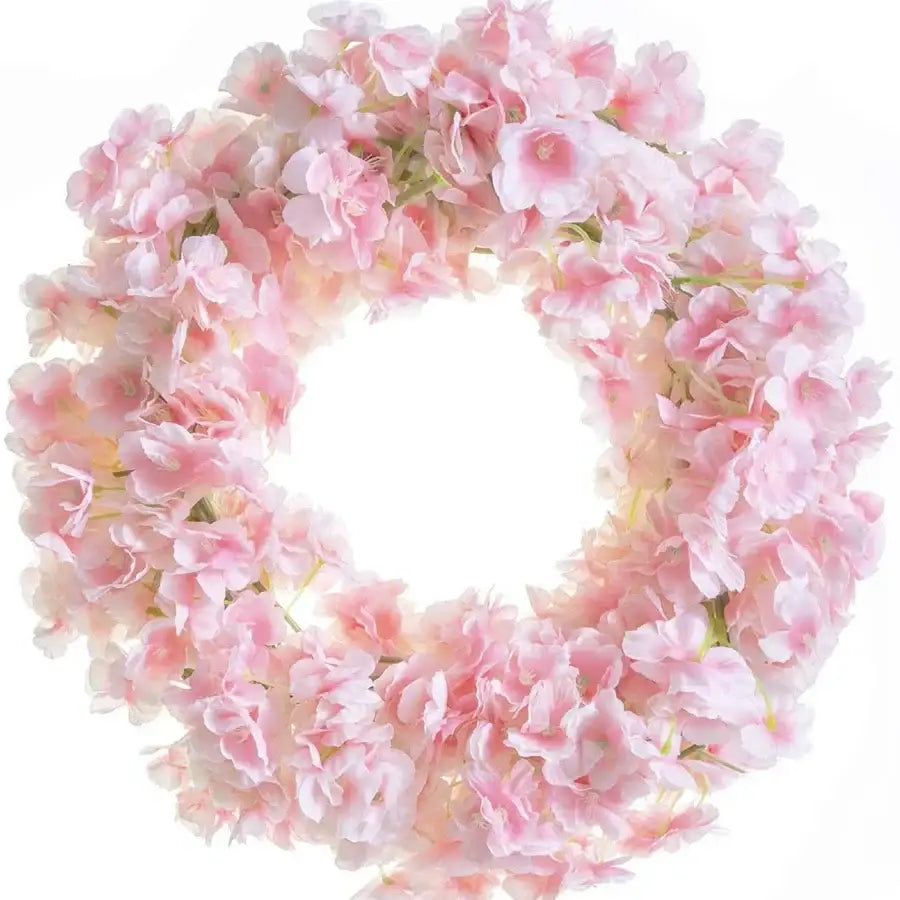A delicate pink decorbites artificial sakura flowers vine wreath with soft layered petals and subtle green stems for decor