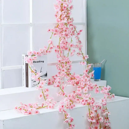Decorbites artificial sakura vine featuring delicate pink artificial sakura flowers with slender green stems for decoration