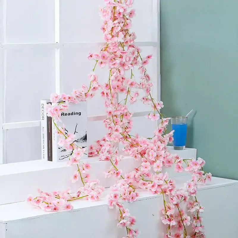 Decorbites artificial sakura vine featuring delicate pink artificial sakura flowers with slender green stems for decoration