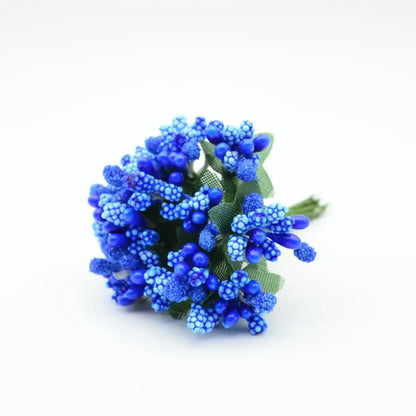 A vibrant blue decorbites artificial stamen flower bouquet with textured petals and green fabric leaves for home decor