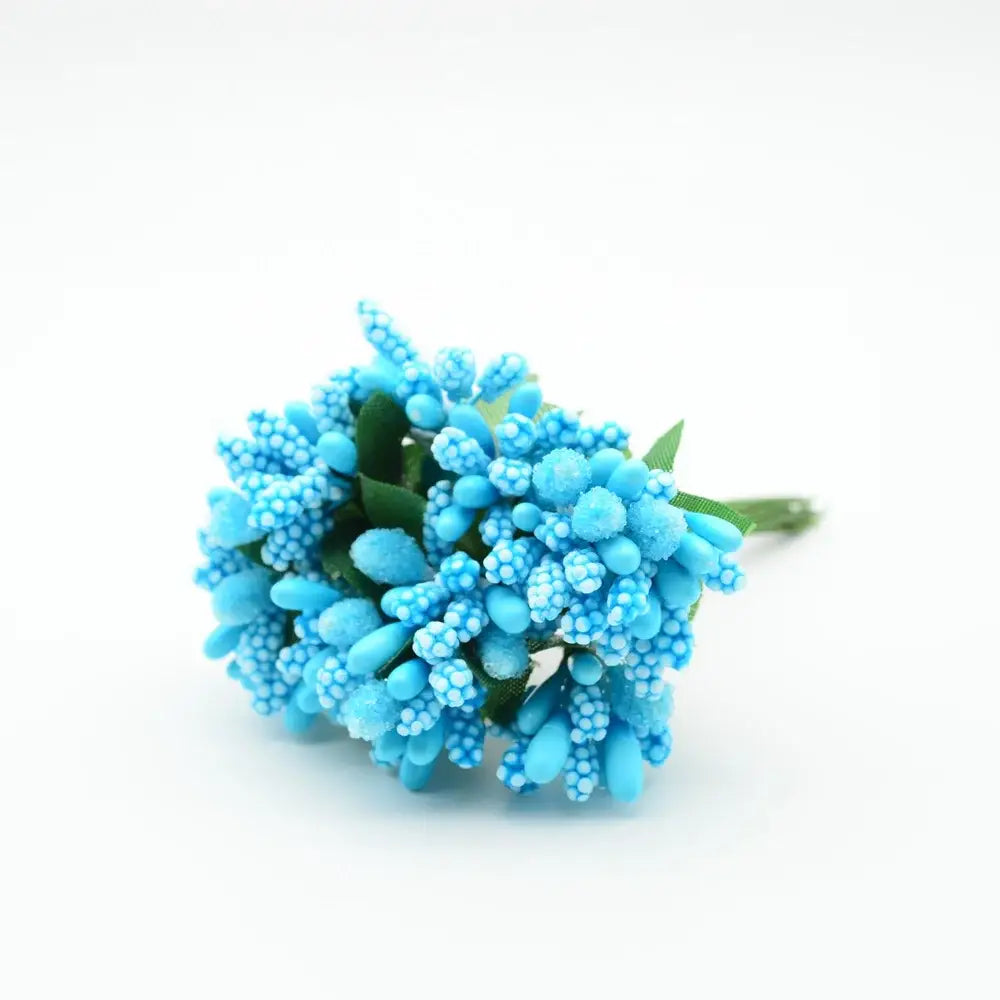 A cluster of blue decorbites artificial stamen flowers with textured bead-like petals and green stems for wedding decor