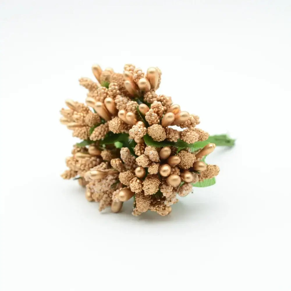 A cluster of metallic gold decorbites artificial stamen flowers with textured spherical blooms and green stems for decor