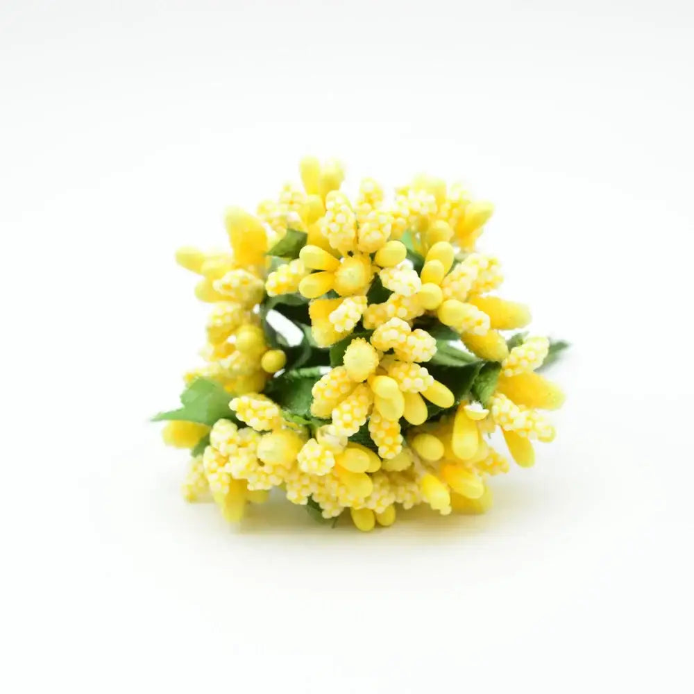 A cluster of yellow decorbites artificial stamen flowers made from textured synthetic material with green leaves