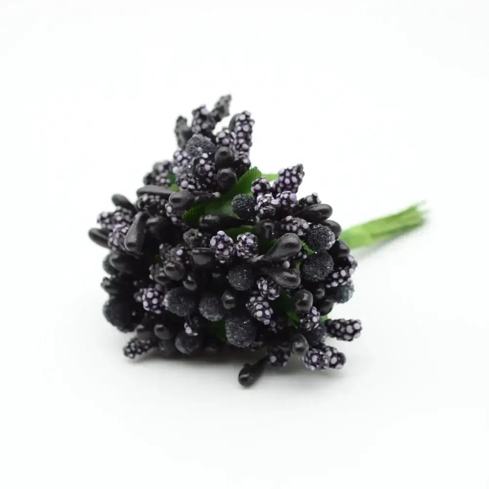 A cluster of black glittery artificial berries with purple speckles and green stems from decorbites artificial stamen flowers