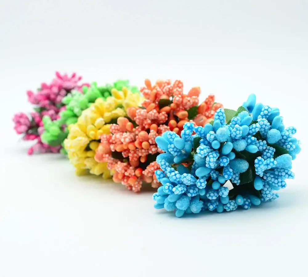 A cluster of decorbites artificial stamen flowers in vibrant pink green yellow orange and blue for home wedding decor