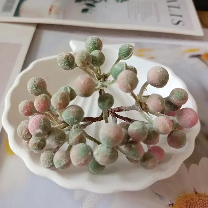 Frosted pink and green artificial berry cluster on white dish in decorbites artificial succulent tree for home décor