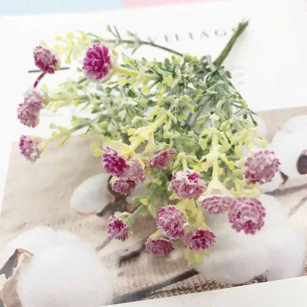 A delicate cluster of pink and white artificial succulent tree flowers with green stems made from synthetic material