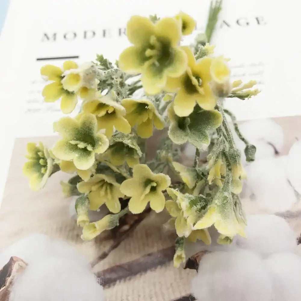 A delicate cluster of pale yellow artificial succulent flowers with green centers on a stem for home décor