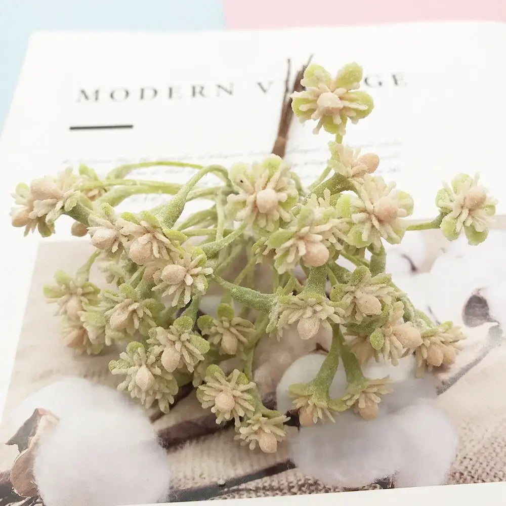 A delicate cluster of green and cream textured petals on a slender stem in the DecorBites artificial succulent tree