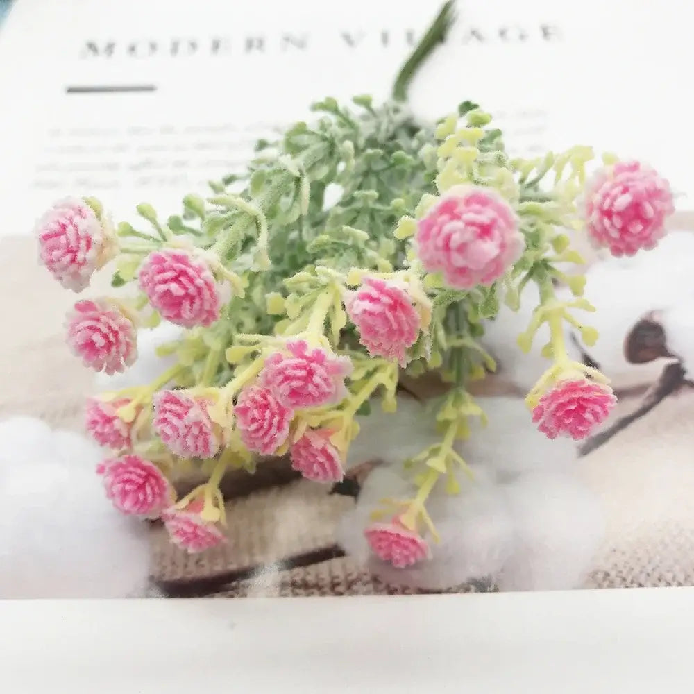 A delicate bouquet of pink artificial succulent tree flowers with green stems and yellow centers for home décor and events