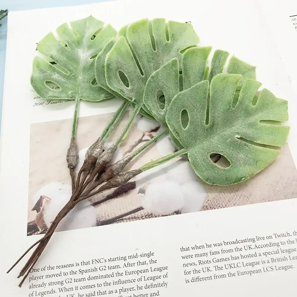 A set of five light green matte monstera leaves with detailed cutouts from the decorbites artificial succulent tree