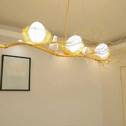 Decorbites™ artistic 3-light beige nest and egg island pendant with cream glass shade featuring golden branch bird design 110v-120v
