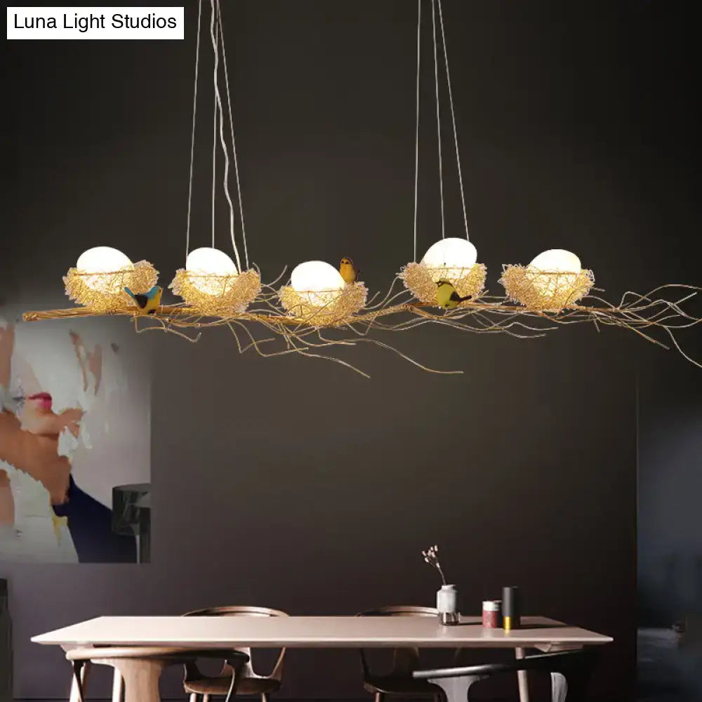 A modern ceiling light featuring five woven golden aluminum wire nests with wood eggs and birds for dining rooms 220v-240v