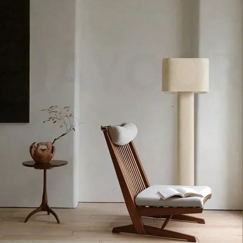 Minimalist wooden lounge chair with slatted back and off-white upholstered seat near decorbites artistic floor lamp