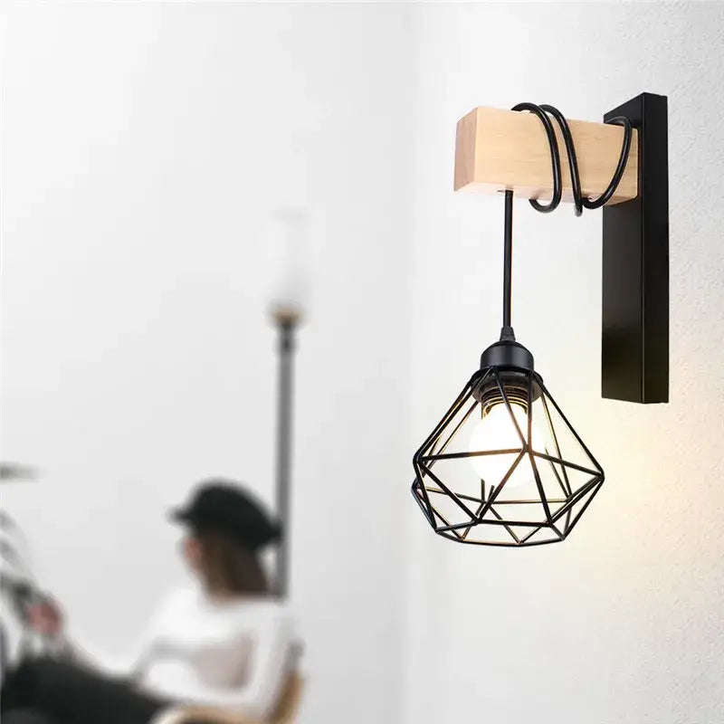 Black metal geometric cage wall lamp with wooden accent and black cord by DecorBites artistic metal iron for indoor use
