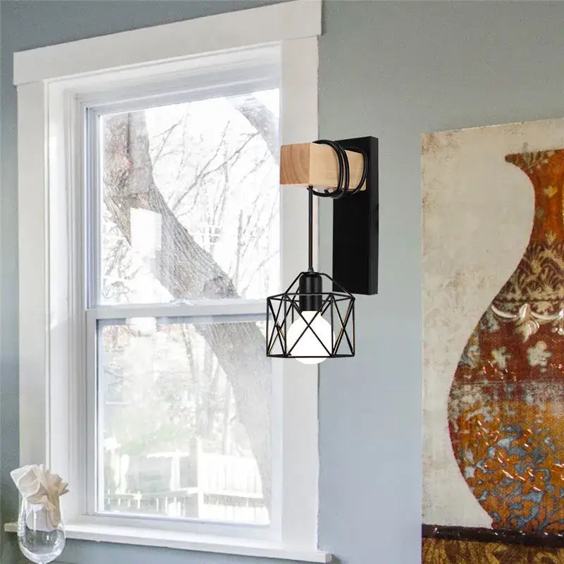 Black metal geometric cage wall lamp with wooden accent and black cord by DecorBites artistic metal iron design