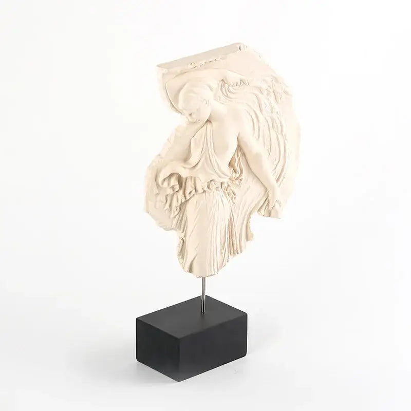 Cream-colored decorbites artistic venus relief sculpture on black base featuring draped venus relief goddess figure