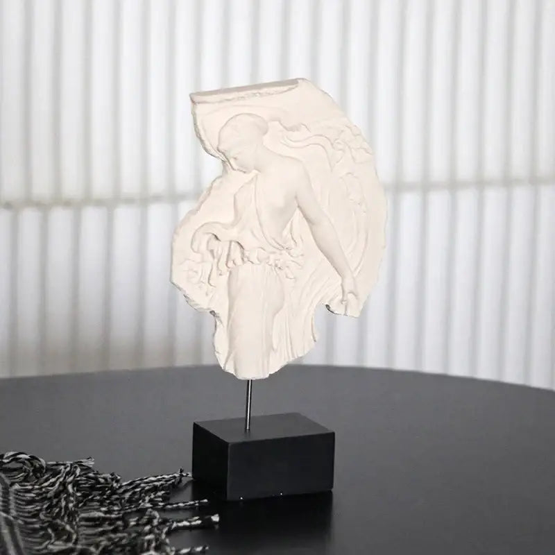 White sculptural bust of a draped figure on black base decorbites artistic venus relief goddess sculpture decor