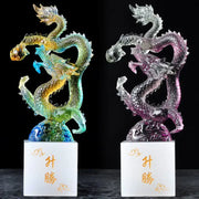Two translucent iridescent dragon figurines with intricate scales on white bases featuring gold chinese characters feng shui ornament