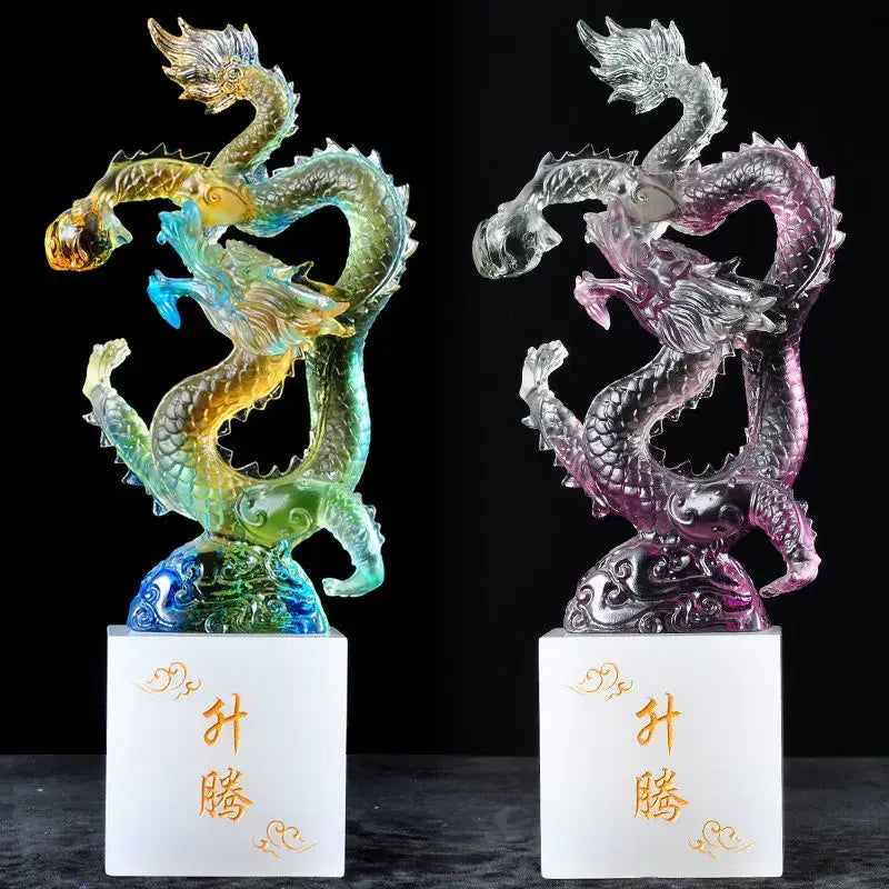 Two translucent iridescent dragon figurines with intricate scales on white bases featuring gold chinese characters feng shui ornament