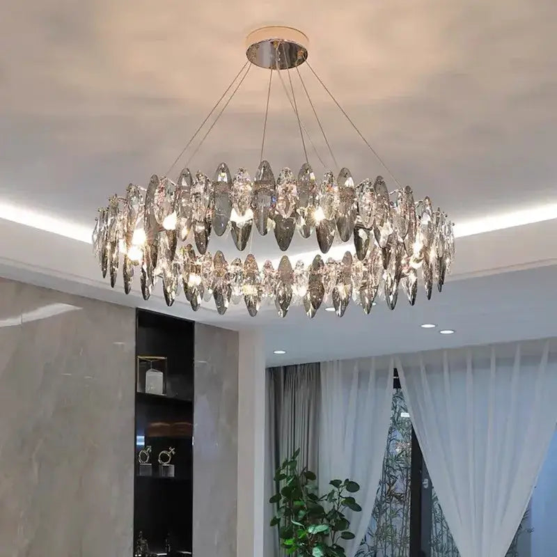 A modern two-tiered decorbites ash crystal chandelier with elongated teardrop crystals and polished chrome ceiling mount