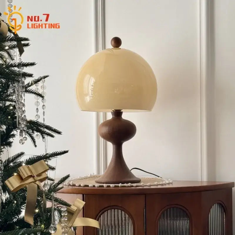 Cream-colored glossy glass dome table lamp with dark ash wood bubble base by decorbites ash wood collection