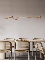 A sculptural light-brown decorbites ash wood led pendant light with a smooth organic bone-like design for indoor decor