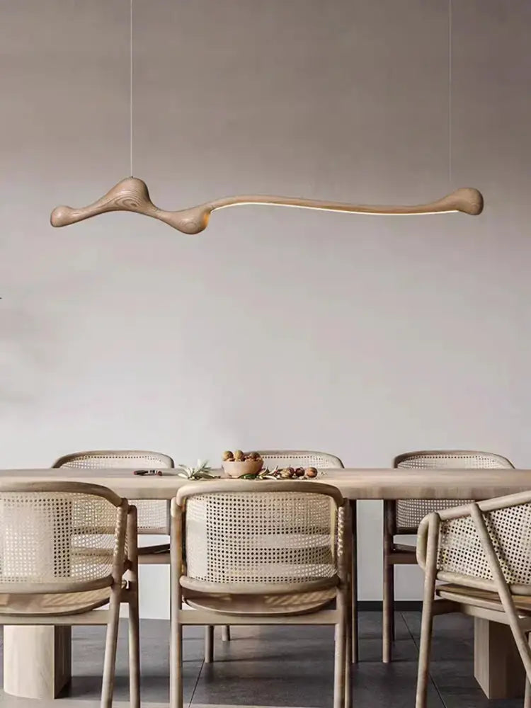 A sculptural light-brown decorbites ash wood led pendant light with a smooth organic bone-like design for indoor decor
