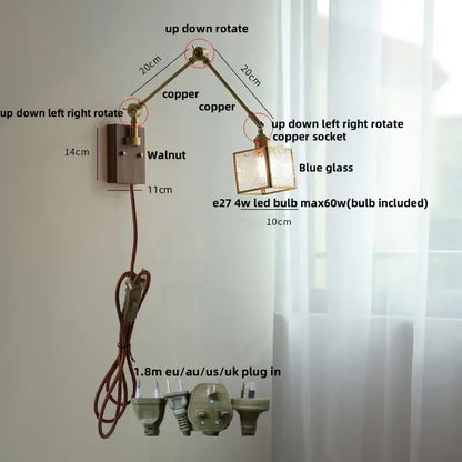 Adjustable DecorBites ash wood LED wall lamp with copper swing arm, blue glass shade, and walnut-finished mounting plate