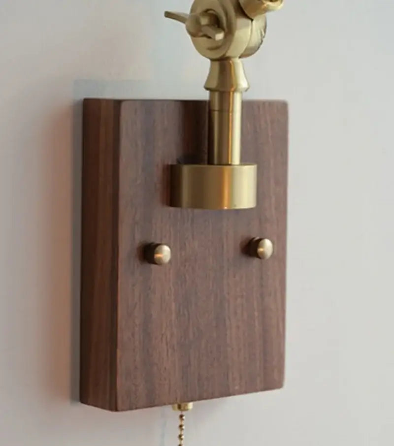 Decorbites ash wood led swing arm wall lamp with brass finish, dark wood base, two decorative knobs, and pull chain switch