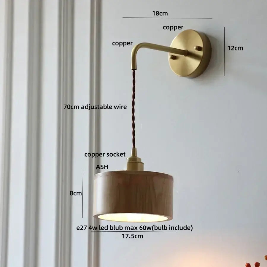 Decorbites ash wood wall lamp with warm copper finish, cylindrical wooden shade, and adjustable braided cord for home decor