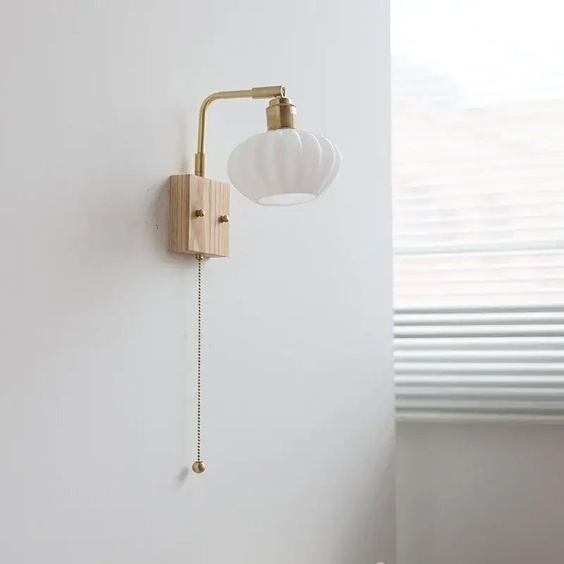 Minimalist decorbites ash wood wall light with brass arm and white glass shade in modern nordic design