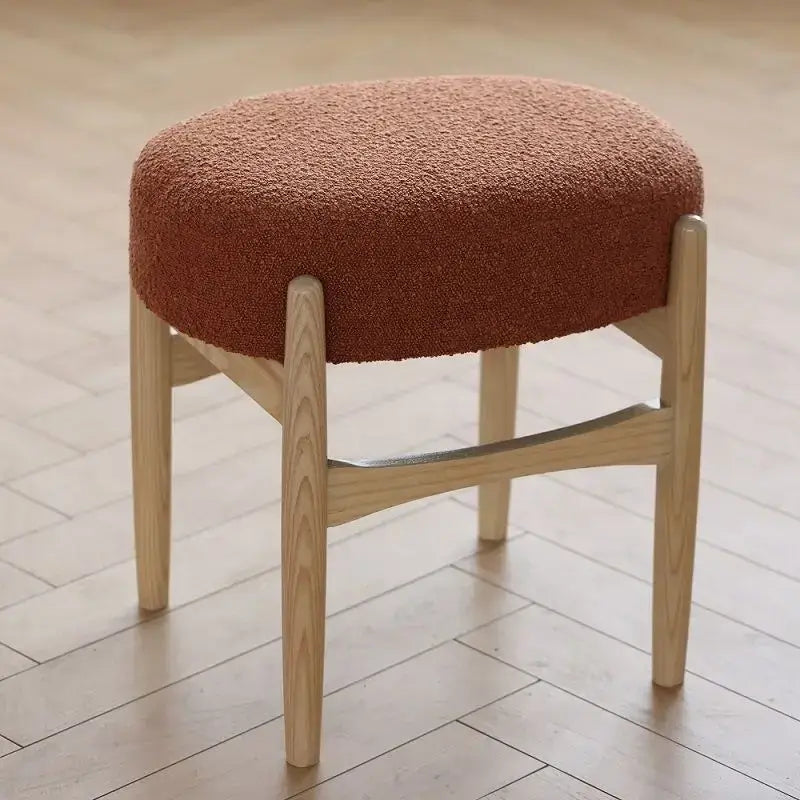 Cozy rust-colored DecorBites ash wood makeup bench with textured fabric seat and light wood legs for small spaces