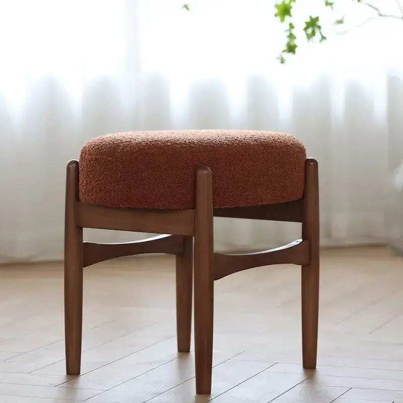 Cozy round decorbites ash wood makeup bench with rust-colored textured fabric seat and sleek wooden legs for small spaces
