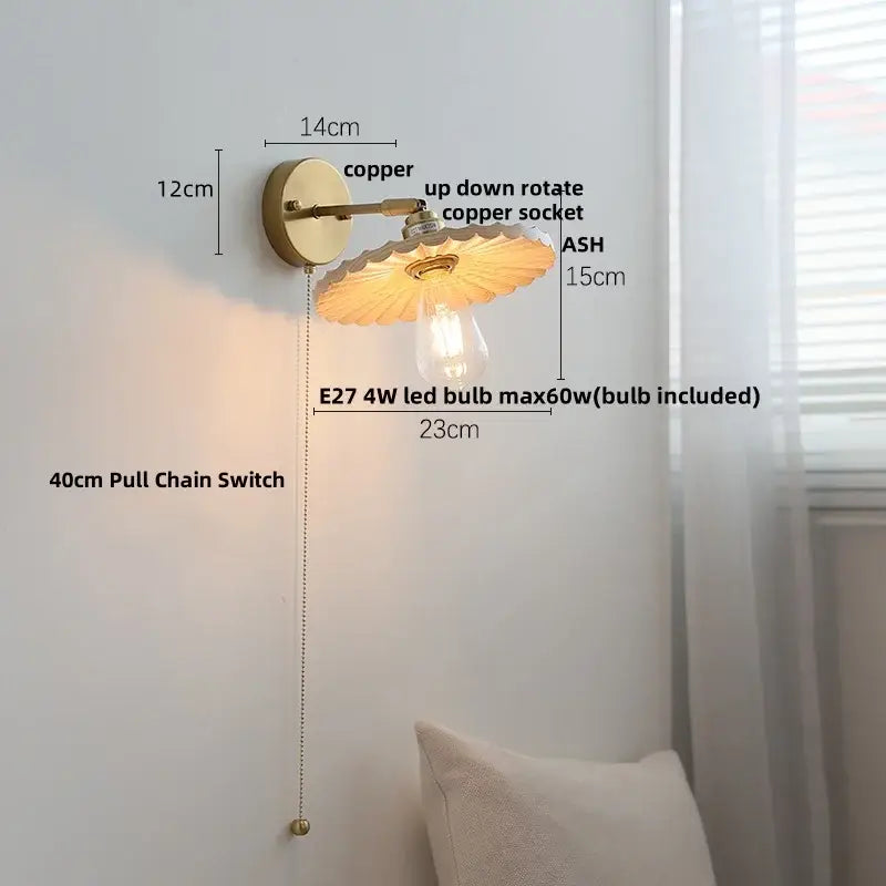 Copper wall lights with scalloped amber glass shade and exposed bulb in decorbites ash wood up down design