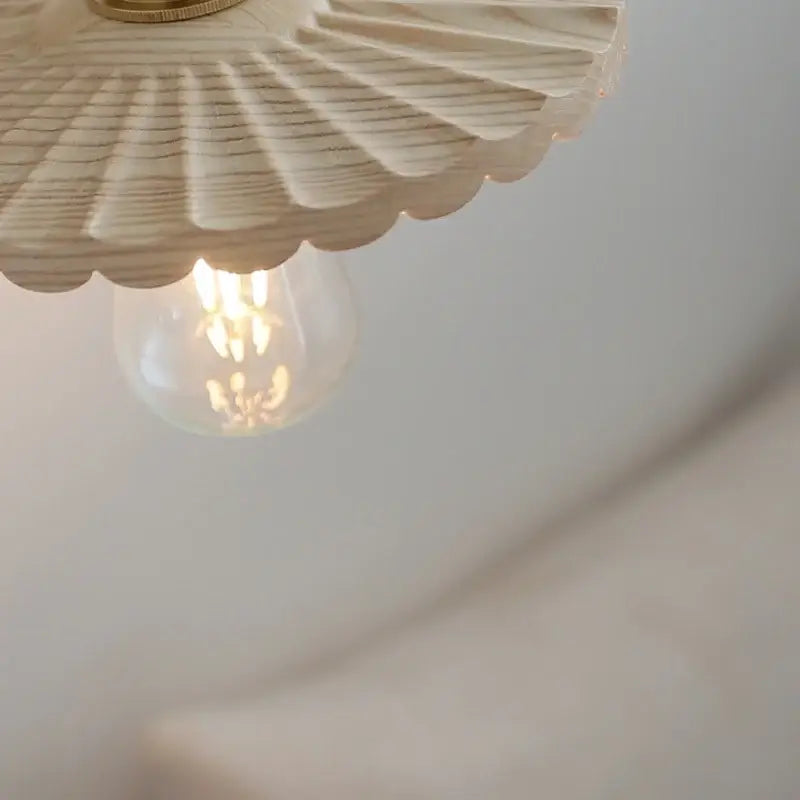 Decorbites ash wood up down wall light in cream with brass fixture and exposed filament bulb for living room stair use